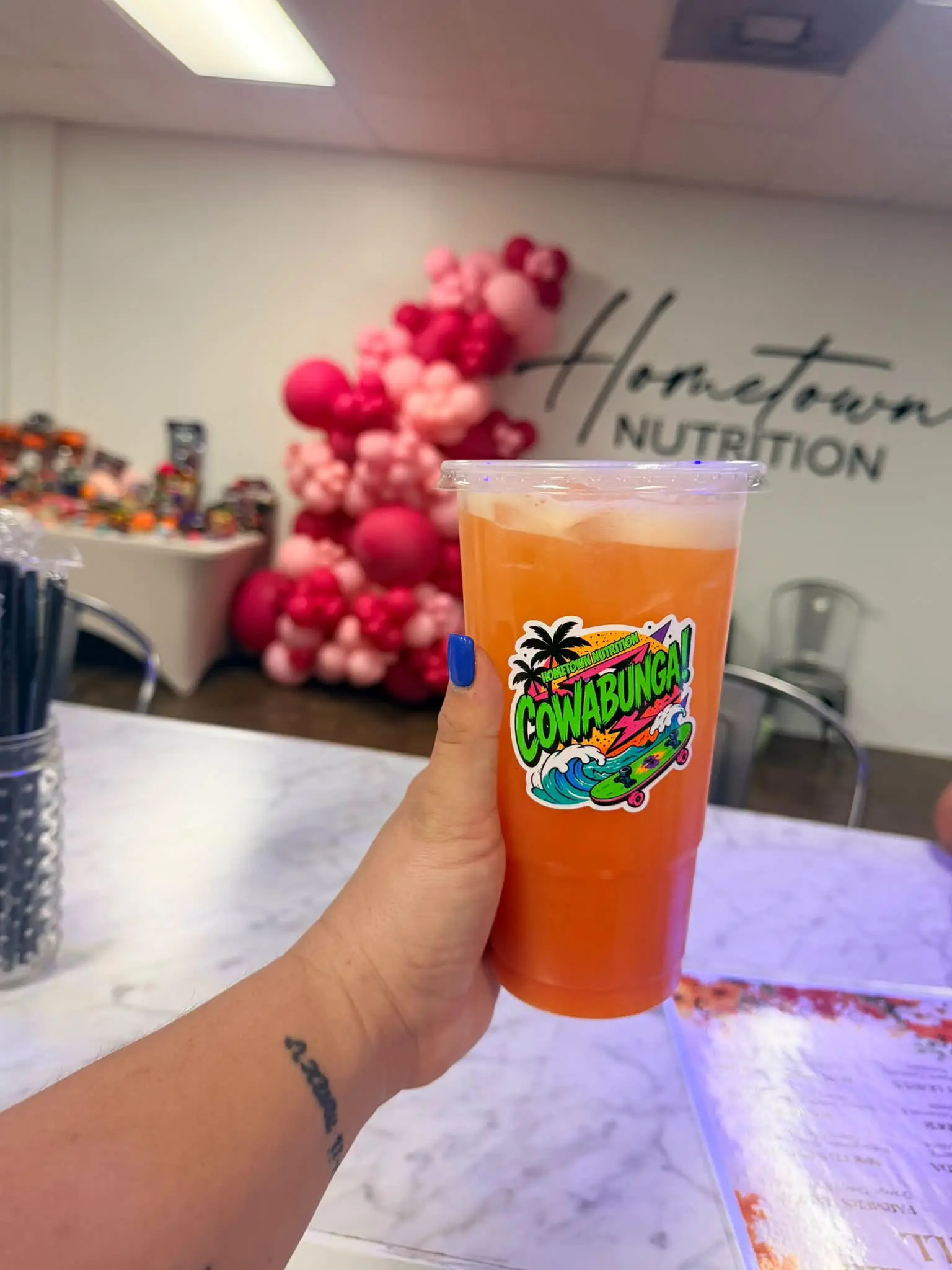 Orange drink on the counter inside Hometown Nutrition
